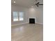 Bright living room features a fireplace, large window with backyard views, and a modern ceiling fan at 105 Watermelon Dr, Franklinton, NC 27525