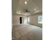 Spacious main bedroom featuring tray ceiling, recessed lights, and plush carpet at 105 Watermelon Dr, Franklinton, NC 27525