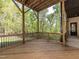 Wooden deck overlooking a wooded lot with black iron railings and a covered ceiling at 144 W Beech Slope Ct, Chapel Hill, NC 27517