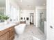 Luxury bathroom featuring marble floors and shower, a freestanding tub, and wood vanity at 144 W Beech Slope Ct, Chapel Hill, NC 27517