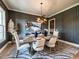 Elegant dining room featuring paneled walls, modern lighting, and a decorative accent rug at 144 W Beech Slope Ct, Chapel Hill, NC 27517