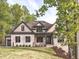 Charming two-story home featuring a stone facade, manicured lawn, and professionally landscaped accents at 144 W Beech Slope Ct, Chapel Hill, NC 27517
