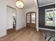 Grand foyer showcasing hardwood floors, designer lighting, a window, and a wood door at 144 W Beech Slope Ct, Chapel Hill, NC 27517