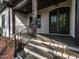 Inviting front porch with stone steps and decorative iron railing, leading to the front door at 144 W Beech Slope Ct, Chapel Hill, NC 27517