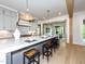 Spacious gray kitchen with a large island, stainless appliances, and wood beam accents at 144 W Beech Slope Ct, Chapel Hill, NC 27517
