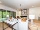Comfortable living room with stone fireplace, modern lighting, and access to the patio at 144 W Beech Slope Ct, Chapel Hill, NC 27517