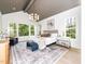 Bright, spacious main bedroom featuring neutral tones, large windows, and a modern chandelier at 144 W Beech Slope Ct, Chapel Hill, NC 27517