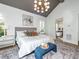 Vaulted ceiling main bedroom with a modern chandelier, ensuite bathroom, and natural light at 144 W Beech Slope Ct, Chapel Hill, NC 27517
