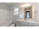 Bathroom with tub-shower combo with white tile and gray countertop sink vanity at 19 Streamline Ct, Lillington, NC 27546
