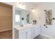 Bathroom with double sink vanity with marble countertop, large mirror, and walk-in closet access at 19 Streamline Ct, Lillington, NC 27546
