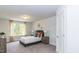Bedroom with neutral carpet and paint, window with curtains, and closet door at 19 Streamline Ct, Lillington, NC 27546