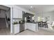 Bright, modern kitchen featuring white cabinets, gray backsplash, stainless steel appliances, and an open layout at 19 Streamline Ct, Lillington, NC 27546