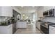 Modern kitchen with white cabinets, stainless steel appliances, and open concept design seamlessly connecting to dining at 19 Streamline Ct, Lillington, NC 27546