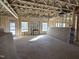 Unfinished living room with exposed beams and a fireplace at 19 Streamline Ct, Lillington, NC 27546