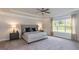 Serene main bedroom featuring tray ceilings, neutral decor, plush carpeting, and soft natural light at 19 Streamline Ct, Lillington, NC 27546