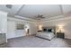 Spacious bedroom features a tray ceiling, ceiling fan, neutral carpet and paint, and ensuite bathroom access at 19 Streamline Ct, Lillington, NC 27546