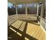 Screened porch with wooden flooring and wooded views at 2422 Field Poppy Dr # 158, Apex, NC 27502