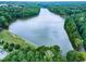 Expansive aerial shot of a large lake surrounded by dense, green forests on a sunny day at 417 E Moore St, Apex, NC 27502