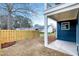 A home's backyard featuring a wooden fence, covered porch, and freshly laid mulch at 417 E Moore St, Apex, NC 27502