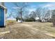 Home exterior with newly planted sod, a shed in the background and a wooden fence at 417 E Moore St, Apex, NC 27502