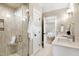 Elegant bathroom featuring a glass enclosed shower, marble floors and vanity at 417 E Moore St, Apex, NC 27502