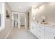 Bright bathroom featuring dual sinks, a glass enclosed shower, toilet room, and a large storage closet at 417 E Moore St, Apex, NC 27502