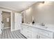 Bright bathroom featuring double sink vanity with quartz countertops and modern fixtures at 417 E Moore St, Apex, NC 27502