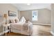 Cozy bedroom featuring hardwood floors, a bed, and a window overlooking the neighborhood at 417 E Moore St, Apex, NC 27502