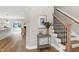 Bright entryway featuring hardwood floors, staircase with decorative railing, and open access to living area at 417 E Moore St, Apex, NC 27502