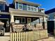 Craftsman style home with a gray exterior, stone accents, and a white picket fence at 417 E Moore St, Apex, NC 27502