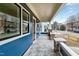 Inviting covered front porch with stone accents, stamped concrete flooring, and blue siding at 417 E Moore St, Apex, NC 27502