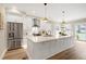 Spacious kitchen featuring stainless steel appliances, white cabinets, and a large center island perfect for entertaining at 417 E Moore St, Apex, NC 27502