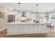 Beautiful kitchen with a large island, stainless appliances, white cabinetry and adjacent breakfast nook at 417 E Moore St, Apex, NC 27502
