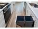 Modern kitchen with stainless steel appliances and pull out trash at 417 E Moore St, Apex, NC 27502