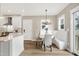 Open kitchen with breakfast nook featuring a built-in bench and backyard view at 417 E Moore St, Apex, NC 27502