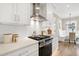 Modern kitchen with stainless steel range, white cabinets, and cozy breakfast nook at 417 E Moore St, Apex, NC 27502