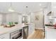 Modern kitchen featuring stainless steel appliances, a large island, and sleek white cabinetry at 417 E Moore St, Apex, NC 27502