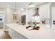 Gorgeous kitchen featuring quartz countertop island, stainless steel appliances, and stylish pendant lighting at 417 E Moore St, Apex, NC 27502