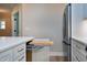 Kitchen island with a pull-out cutting board and stainless steel refrigerator at 417 E Moore St, Apex, NC 27502