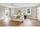 Large main bedroom with hardwood floors, neutral paint, windows and ceiling fan at 417 E Moore St, Apex, NC 27502