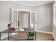 Bright office featuring French doors, hardwood floors, and a modern desk area at 417 E Moore St, Apex, NC 27502
