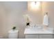 Bright powder room with marble countertops and natural light from a window at 417 E Moore St, Apex, NC 27502