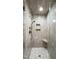 Newly tiled shower featuring a bench, niche and rainfall shower head, offering spa-like experience at 417 E Moore St, Apex, NC 27502