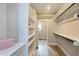 Walk-in closet with closet system and natural light from a window at the end at 417 E Moore St, Apex, NC 27502