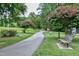 A picturesque walking path winds through a park with benches and flowering trees in view at 417 E Moore St, Apex, NC 27502
