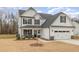 Two-story house with white siding, gray roof, and stone accents at 49 Lupin Dr, Smithfield, NC 27577