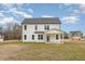 Rear view of two-story house, showcasing backyard and landscaping at 49 Lupin Dr, Smithfield, NC 27577