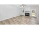 Living room with fireplace, wood-look floors and French doors at 49 Lupin Dr, Smithfield, NC 27577