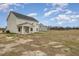 The spacious backyard features a view of neighboring houses and blue sky at 54 Barony Ln, Smithfield, NC 27577