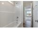 Bright white bathroom with a shower and bathtub and view to carpeted bedroom at 54 Barony Ln, Smithfield, NC 27577